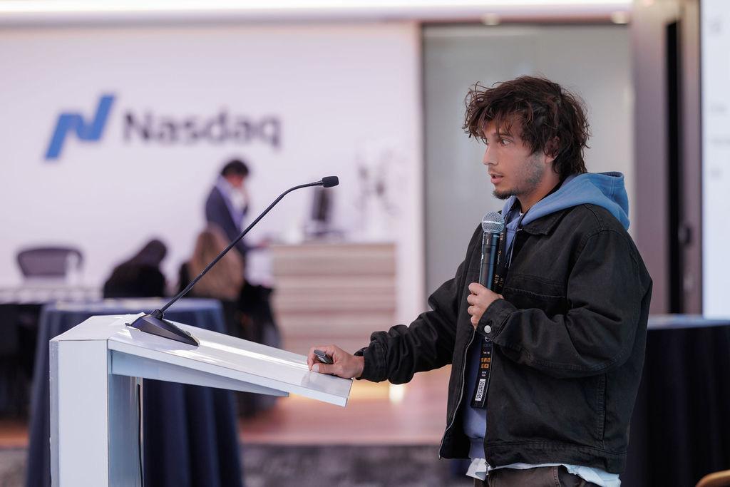 A speaker addressing the room from the podium at Nasdaq