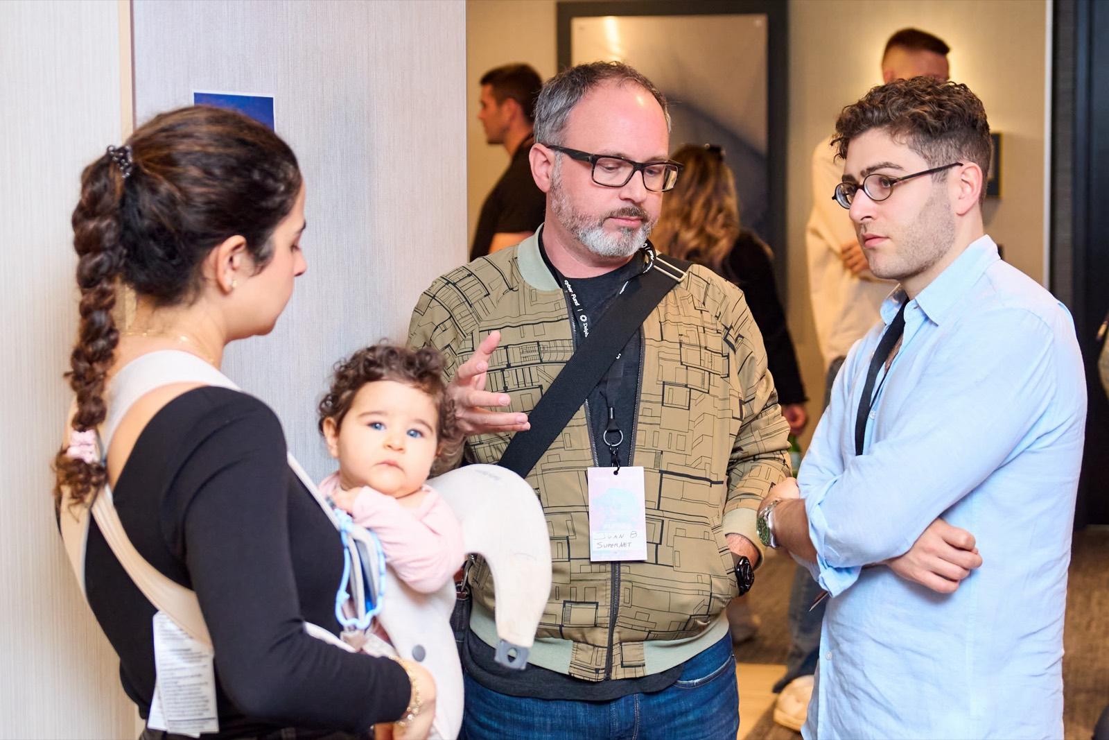 Three attendees talking together at the dAGI Summit